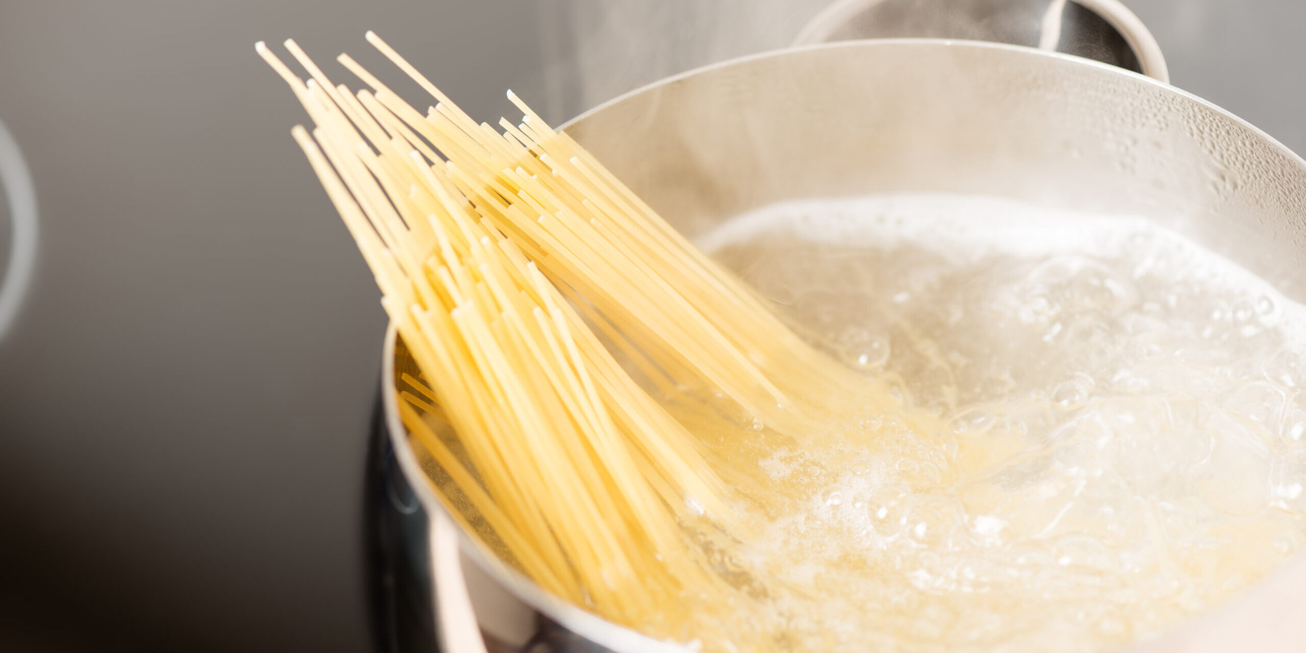 Pan with spaghetti cooking in boiling water
